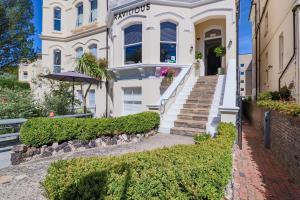 Casa blanca con escaleras y sombrilla en Ravilious, en Eastbourne