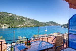 a balcony with a table and a view of the water at Galini Studios in Sivota