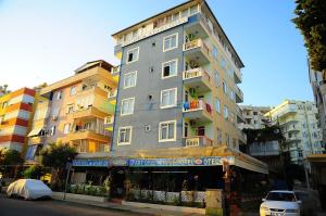 a tall building on a city street with a building at Best Life Apart Hotel in Alanya