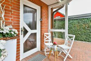 a patio with two chairs and a glass table at Ferienhaus 1 Fuchsweg in Stralsund
