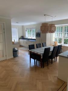 cocina y comedor con mesa y sillas en Vakantiehuis Villa Zeewolde, en Zeewolde