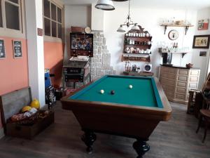 a living room with a pool table in it at la Ganse Blanche in Usson-en-Forez