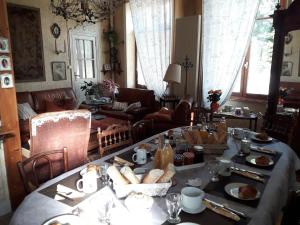 a living room with a table with food on it at la Ganse Blanche in Usson-en-Forez