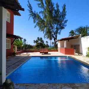 a swimming pool in the backyard of a house at Casa Cohiba in Cumbuco
