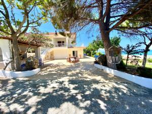 a house with a tree in the middle of a driveway at Villa Aegean in Mourteri