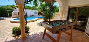 a chess board in front of a house with a pool at Casa Del Sol in L'Ametlla de Mar