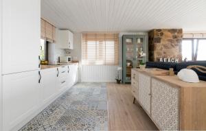 a kitchen with white cabinets and a counter top at La Cabaña de la playa in Ajo