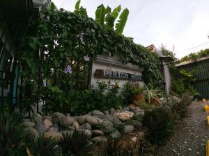 a building with a sign that reads petula ville at Hotel Perico Azul & Surf Camp in Jacó