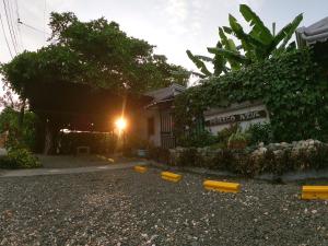 a yard with yellow objects on the ground in front of a building at Hotel Perico Azul & Surf Camp in Jacó