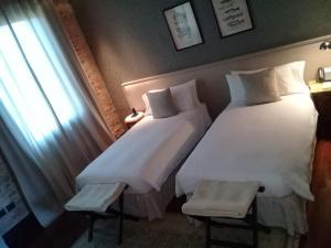 A bed or beds in a room at Factoria Hotel