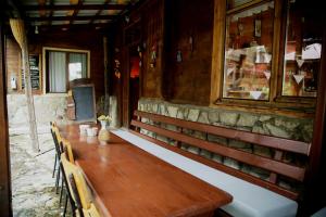 a long wooden table and chairs in a building at Kuşpuni Mountain Lodge in Ayder Yaylasi