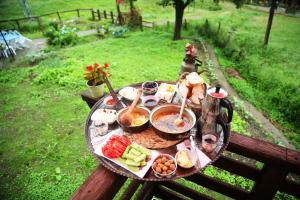 a picnic table with food on top of it at Kuşpuni Mountain Lodge in Ayder Yaylasi