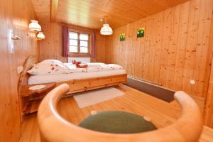 a room with a bed in a wooden cabin at Hof Erath in Au im Bregenzerwald