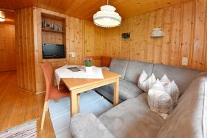 a living room with a couch and a table at Hof Erath in Au im Bregenzerwald