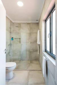 a white toilet sitting next to a shower in a bathroom at Lisbon Serviced Apartments - Campos in Lisbon
