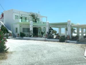 a large white house with a gravel driveway at The Cliff Reflections - Adults Only in Megalochori