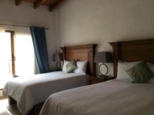 Postel nebo postele na pokoji v ubytování Hotel Concierge Flor y Canto