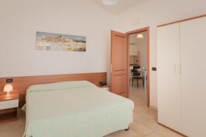 Un pat sau paturi într-o cameră la Residence Le Fontane