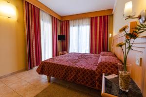 a hotel room with a bed and a window at Hotel San Andrea in Xlendi +22 photos