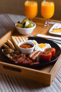 a plate of breakfast food with eggs sausage and toast at Hotel San Andrea in Xlendi