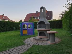 een speeltuin in een tuin met een speelplaats bij Familienfreundliches Ferienhaus AMARA mit Garten und Terrasse - Friedrichshafen am Bodensee in Friedrichshafen