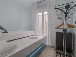 a white bedroom with a bed and a desk at Apartamento San Lorenzo Casco Antiguo in Seville