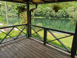a porch with a view of a river at Brvnara na obali reke Drine in Beserovina