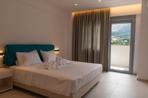 Кровать или кровати в номере Aquamarine Villas +21 фотография