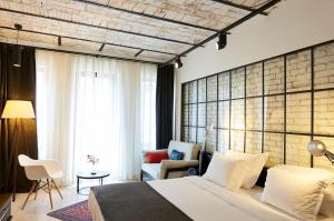 A bed or beds in a room at Magnova Studios