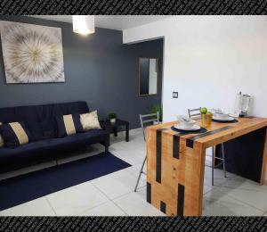 a living room with a couch and a table at Modern Apartment in Rosarito