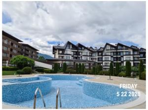 a large swimming pool in front of a building at Studio L006 in Aspen Golf in Bansko