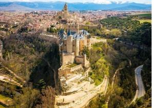 an aerial view of a large castle on a hill at Hostal Plaza in Segovia