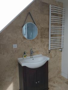 a bathroom with a sink and a mirror at Agroturystyka Giławy in Giławy