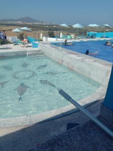 a swimming pool with a hose in the water at Maliana Star in Tétouan