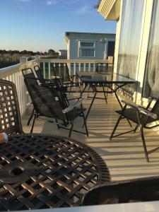 a deck with chairs and tables on a house at G17 The Chase , Ingoldmells, Skegness in Ingoldmells +3 photos