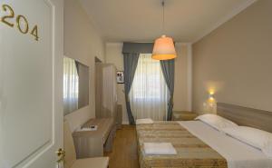 Postel nebo postele na pokoji v ubytování Hotel La Pace