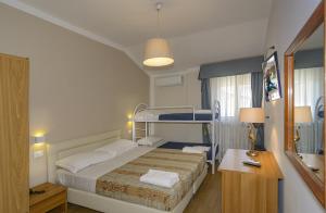 Postel nebo postele na pokoji v ubytování Hotel La Pace