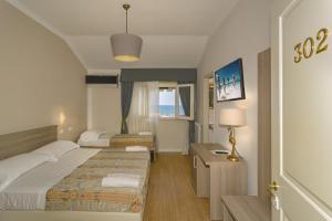 Postel nebo postele na pokoji v ubytování Hotel La Pace