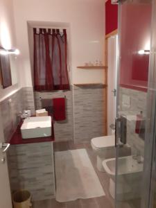 a bathroom with a sink and a toilet at Casa Calù in Genoa