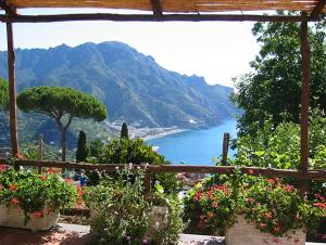 a view of a body of water with flowers at Villa Casale Ravello Residence in Ravello
