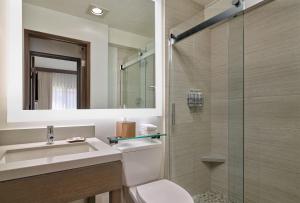 a bathroom with a toilet and a sink and a shower at Palmoro House in Santa Barbara