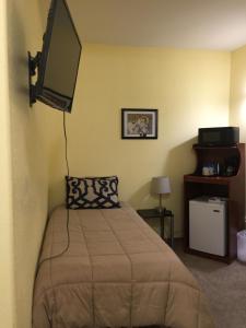 a bedroom with a bed and a flat screen tv at Cantwell Lodge in Cantwell