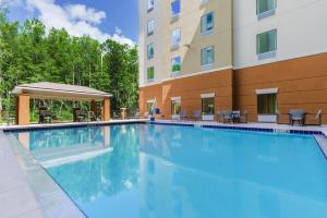 a swimming pool in front of a building at Candlewood Suites - Orlando - Lake Buena Vista, an IHG Hotel in Orlando