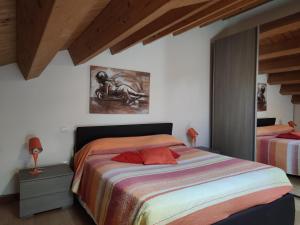 a bedroom with two beds and a painting on the wall at Alberghiera Venezia in Venice