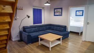 a living room with a blue couch and a table at Apartamenty Park in Ciechocinek