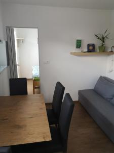 a living room with a wooden table and a couch at Apartment Damijan in Bled