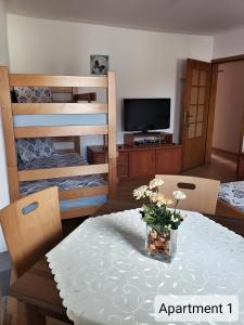 uma sala de estar com uma mesa e beliches em Apartments Doris em Kruševo
