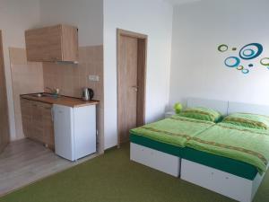 A bed or beds in a room at Penzion a hospůdka U Anny