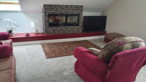 a living room with two chairs and a fireplace at Bridgeburn Apartment in Letterkenny
