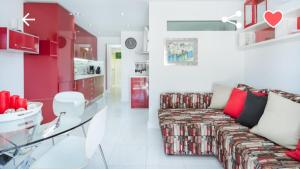 a living room with a couch and a glass table at Bungalow con piscina Maspalomas in Maspalomas